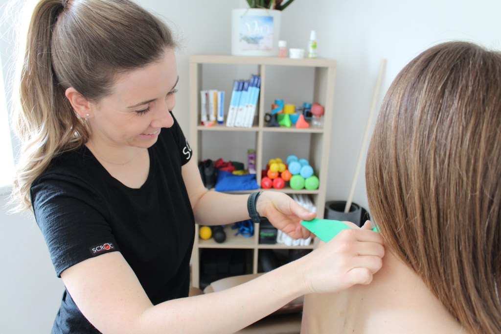 Bild zeigt Physiotherapeutin beim Tapen